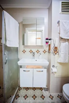 a white bathroom with a sink and a shower at Linfer Hotel Taksim in Istanbul