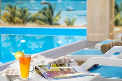 a drink sitting on a table next to a pool at Ramada Plaza by Wyndham Silivri in Silivri