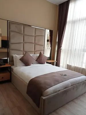 a bedroom with a large bed with a large headboard at Berfinn Hotel Ortaköy in Istanbul