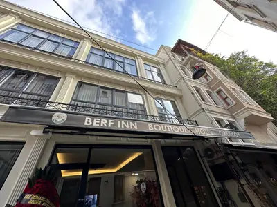 a building with a sign for the entrance to a beer inn boutique at Berfinn Hotel Ortaköy in Istanbul