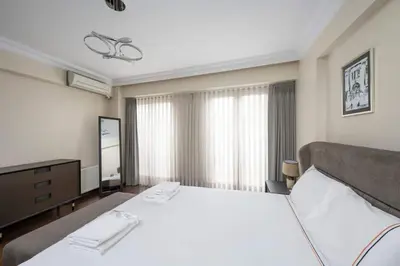 a bedroom with a large white bed and a mirror at Lovely bright central modern 1Bed1Bath! #159 in Istanbul
