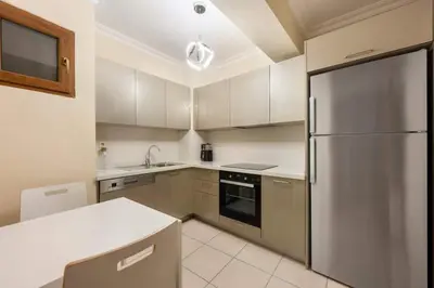 a kitchen with a stainless steel refrigerator and white cabinets at Lovely bright central modern 1Bed1Bath! #159 in Istanbul