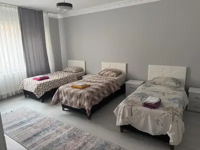 a bedroom with two twin beds and a rug at Only For Families Apartment in Istanbul
