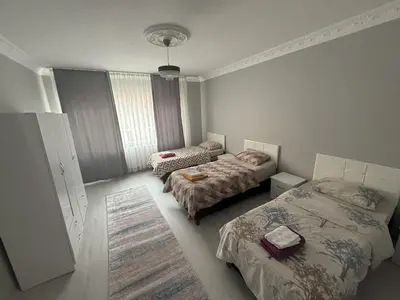 a room with two beds and a room with a bed sqor at Only For Families Apartment in Istanbul