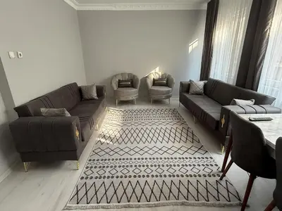 a living room with two couches and two chairs at Only For Families Apartment in Istanbul