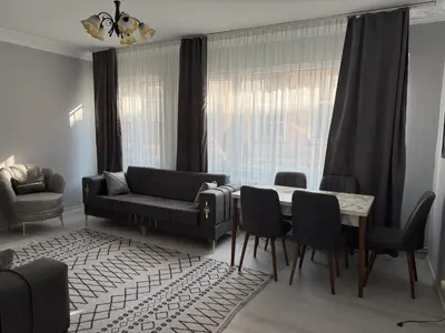 a living room with a couch and a table and chairs at Only For Families Apartment in Istanbul