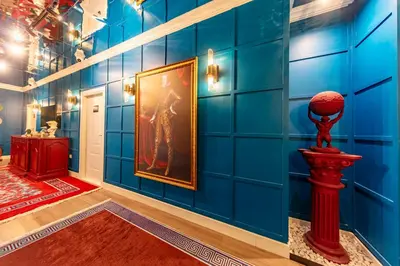 a room with blue walls and a painting on the wall at Hexa Suites Hotel in Istanbul