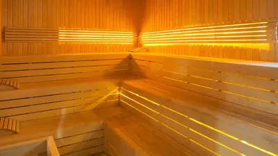 an empty sauna with wooden benches and lights at Linkinn Luxury Residence & Spa in Esenyurt