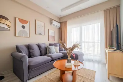 a living room with a purple couch and a table at Linkinn Luxury Residence & Spa in Esenyurt