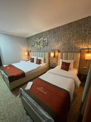 a hotel room with two beds in it at Marrakeschotel in Tuzla