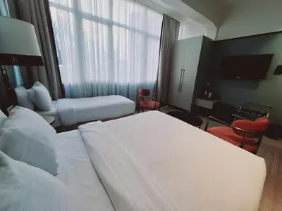 a hotel room with two beds and a window at EA Exclusive Hotel in Istanbul