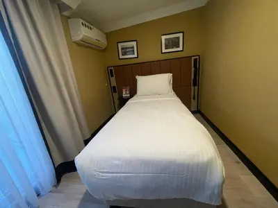 a large white bed in a room with a window at EA Exclusive Hotel in Istanbul