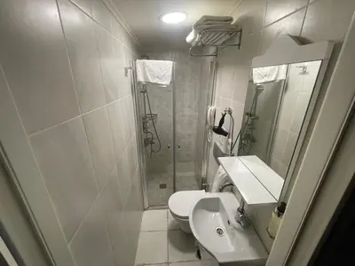 a bathroom with a shower and a toilet and a sink at EA Exclusive Hotel in Istanbul