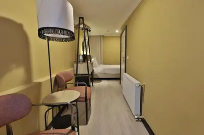 a room with a table and chairs and a bed at EA Exclusive Hotel in Istanbul