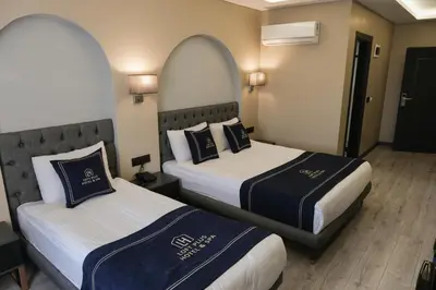 a hotel room with two beds in a room at Plus Hotel & Private Transportation İstanbul Airport-By Loft in Arnavutköy