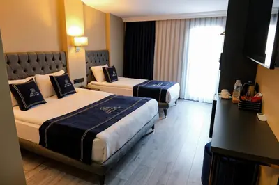 a hotel room with two beds and a window at Plus Hotel & Private Transportation İstanbul Airport-By Loft in Arnavutköy