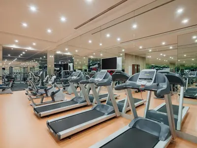 a gym with rows of treadmills and elliptical machines at Selectum City Ataşehir in Istanbul