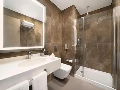 a bathroom with a sink and a toilet and a shower at Selectum City Ataşehir in Istanbul