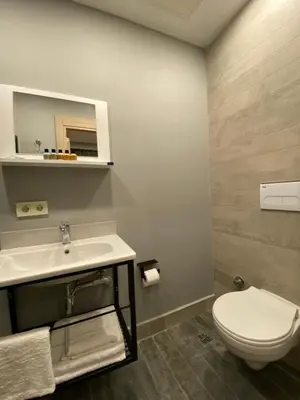 a bathroom with a white toilet and a sink at Li Hotel Pera in Istanbul