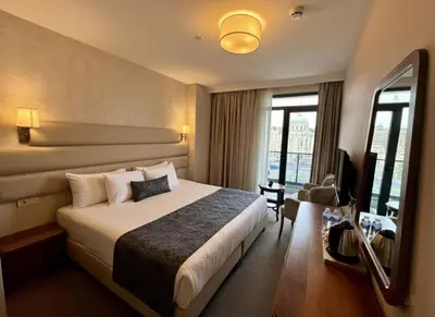 a hotel room with a bed and a television at Istanbul Midpoint Hotel in Istanbul