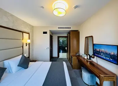 a hotel room with a bed and a large television at Istanbul Midpoint Hotel in Istanbul