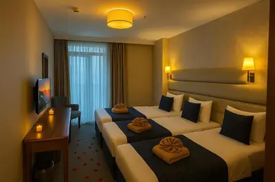 a hotel room with two beds and a television at Istanbul Midpoint Hotel in Istanbul