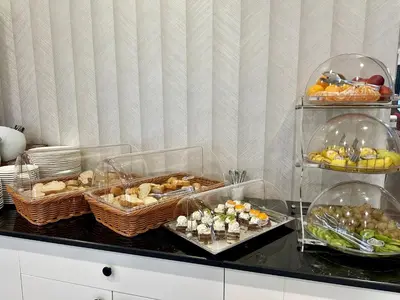 a buffet with several trays of different types of food at Istanbul Midpoint Hotel in Istanbul