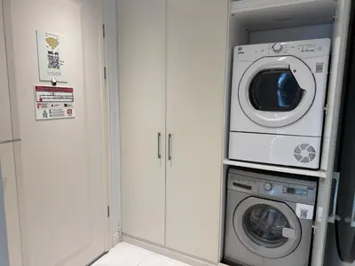 a laundry room with a washer and a washing machine at Elysium Soul Residence in Istanbul