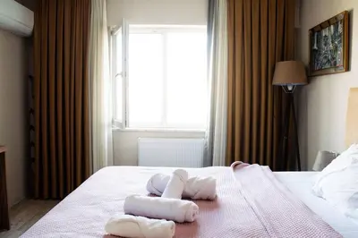 a bedroom with towels on a bed with a window at Deluxe King Suite AS3 in Esenyurt