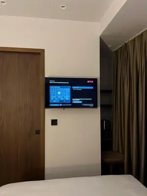 a bedroom with a television on a wall at PALMERA HAGIA SOPHIA Hotel in Istanbul