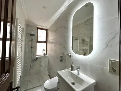 a white bathroom with a sink and a mirror at Botter Dream House in Istanbul