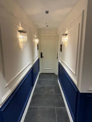 a hallway with blue and white walls and a door at Prime Bosphorus Hotel in Istanbul