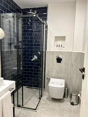 a bathroom with a toilet and a glass shower at Prime Bosphorus Hotel in Istanbul