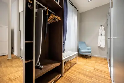 a dressing room with a closet and a chair at DeCamondo Residence in Istanbul