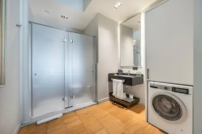 a laundry room with a washing machine and a mirror at DeCamondo Residence in Istanbul