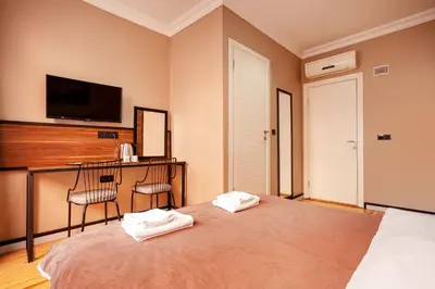 a bedroom with a bed with two towels on it at Aram Kerasi Rooms in Istanbul