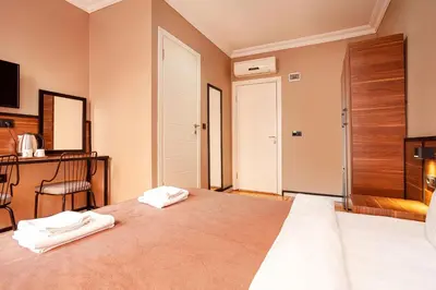 a bedroom with a bed with two towels on it at Aram Kerasi Rooms in Istanbul