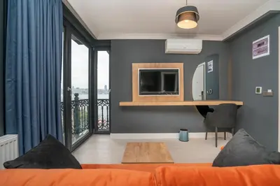 a living room with a bed and a television and a balcony at 216 Bosphorus in Istanbul