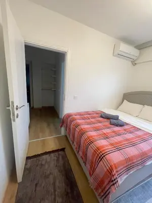 a bedroom with a bed with a red blanket at Two Bedroom King Suite IH19 in Esenyurt