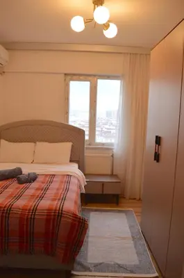 a bedroom with a bed and a window at Two Bedroom King Suite IH19 in Esenyurt