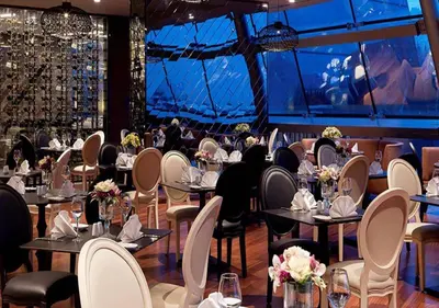 a restaurant with tables and chairs with people sitting at them at Prime Istanbul in Istanbul