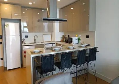a kitchen with a large island with bar stools at Prime Istanbul in Istanbul