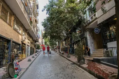 two people walking down a cobblestone street at TAKSİM PERA House in Istanbul
