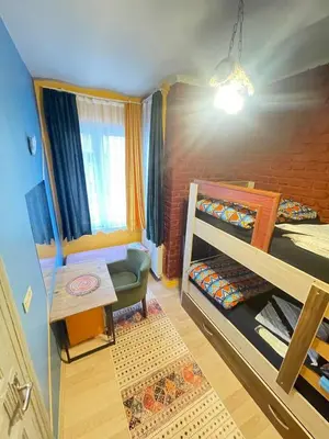 a small room with two bunk beds and a table at TAKSİM PERA House in Istanbul