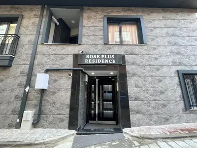 a building with a sign that readsrosis hits releasing at Rose Plus Residence in Istanbul