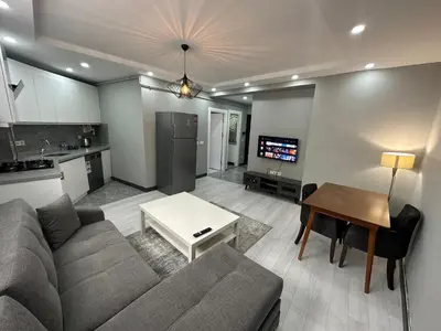 a living room with a couch and a table at Rose Plus Residence in Istanbul