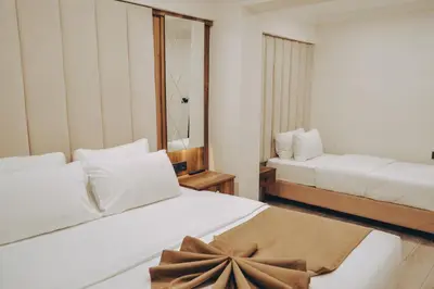 a hotel room with two beds and a mirror at Galata Master Hotel in Istanbul