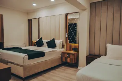 a hotel room with two beds and a mirror at Galata Master Hotel in Istanbul