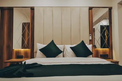 a bedroom with a bed with green and white pillows at Galata Master Hotel in Istanbul