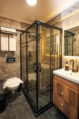 a bathroom with a shower and a toilet and a sink at Galata Master Hotel in Istanbul